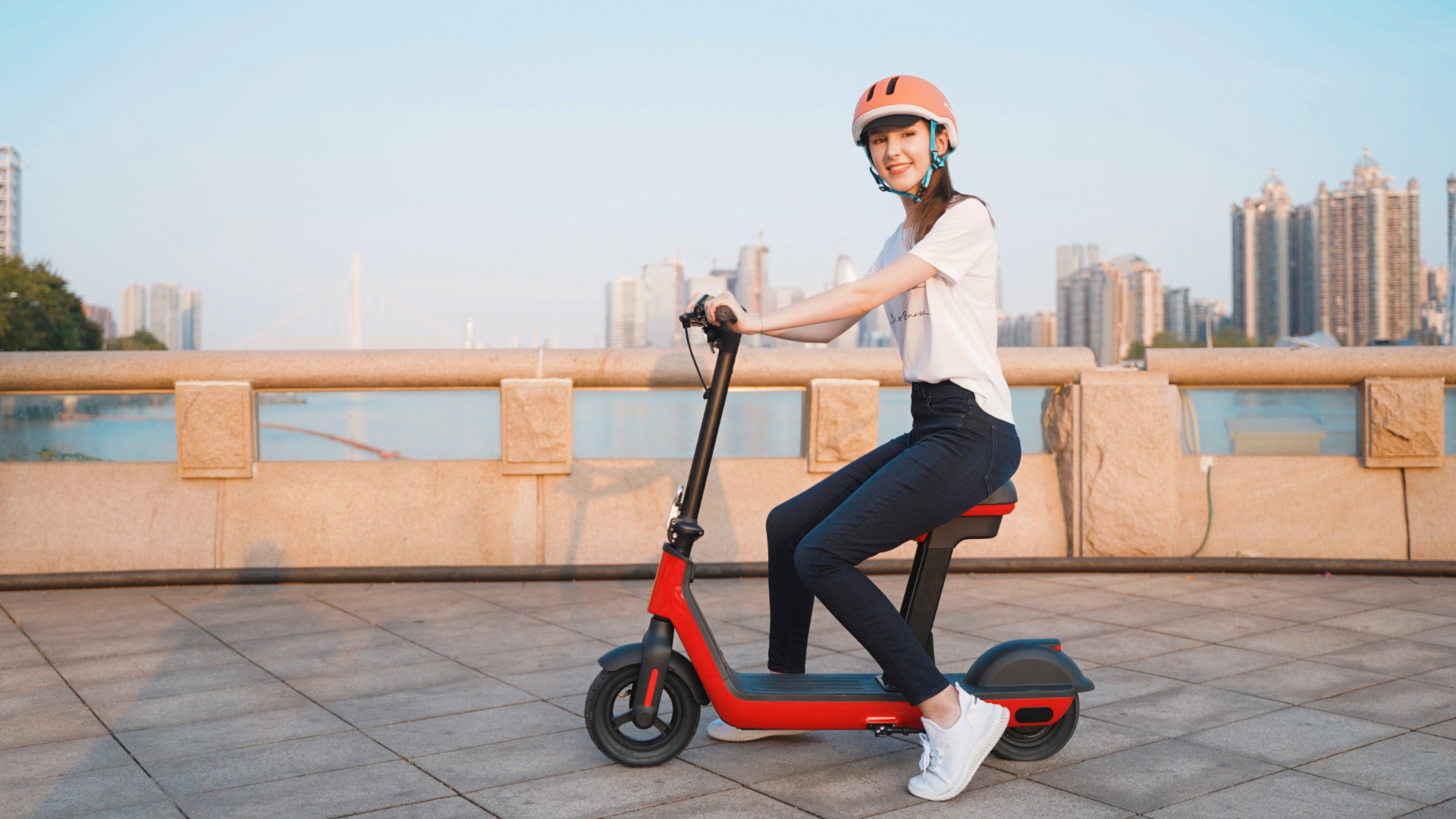 Woman using helmet, one of the electric scooter safety tips.