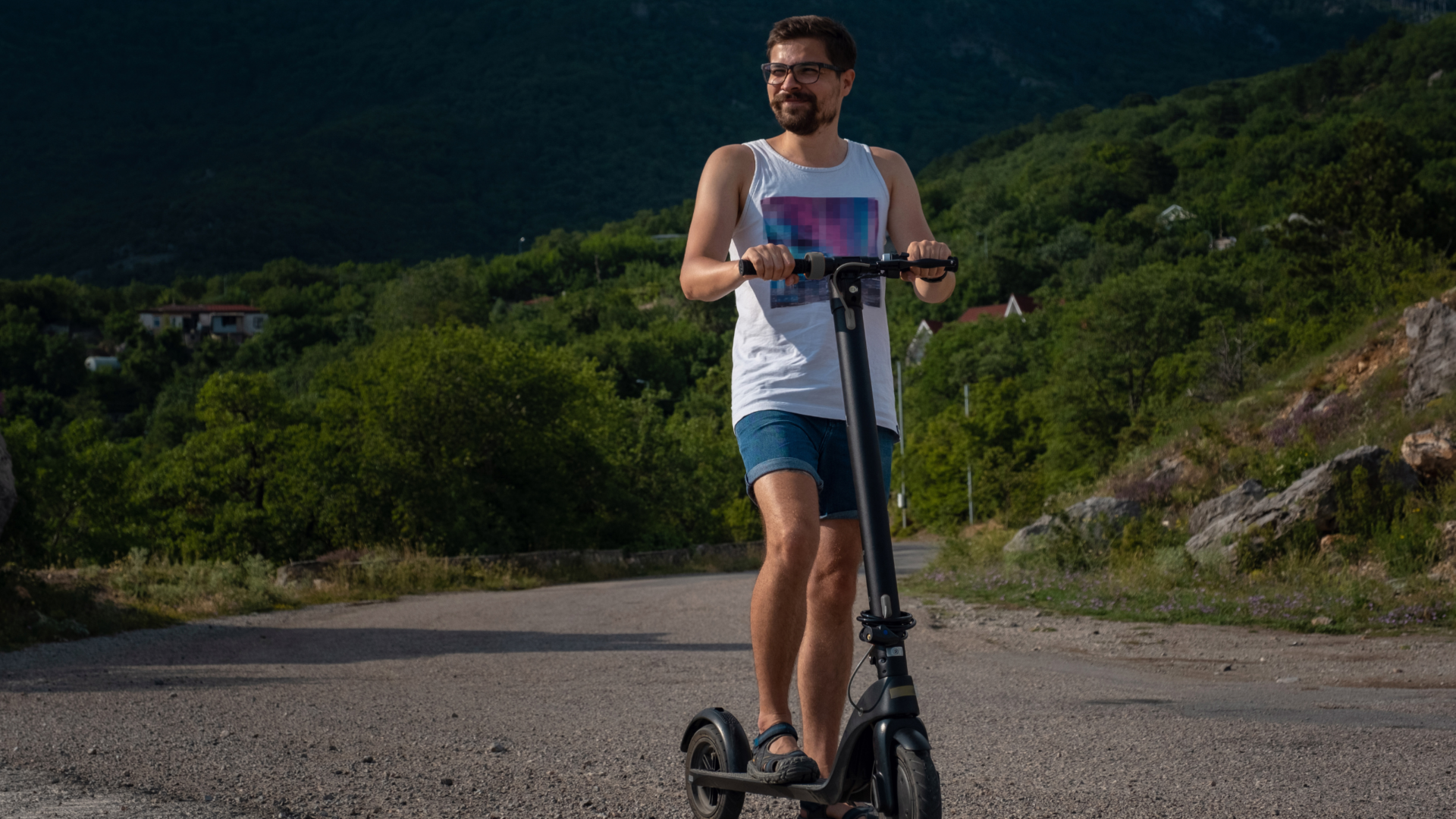 Man hill climbing with electric scooter.