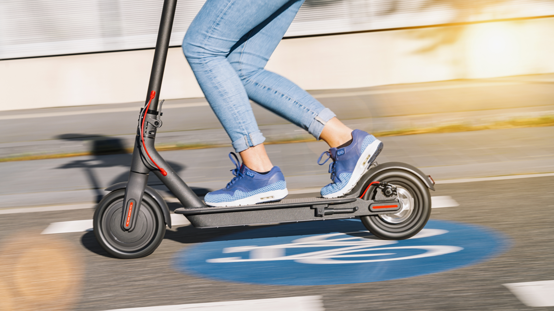 Woman riding on a electric scooter showing how to electric scooter street legality is like.