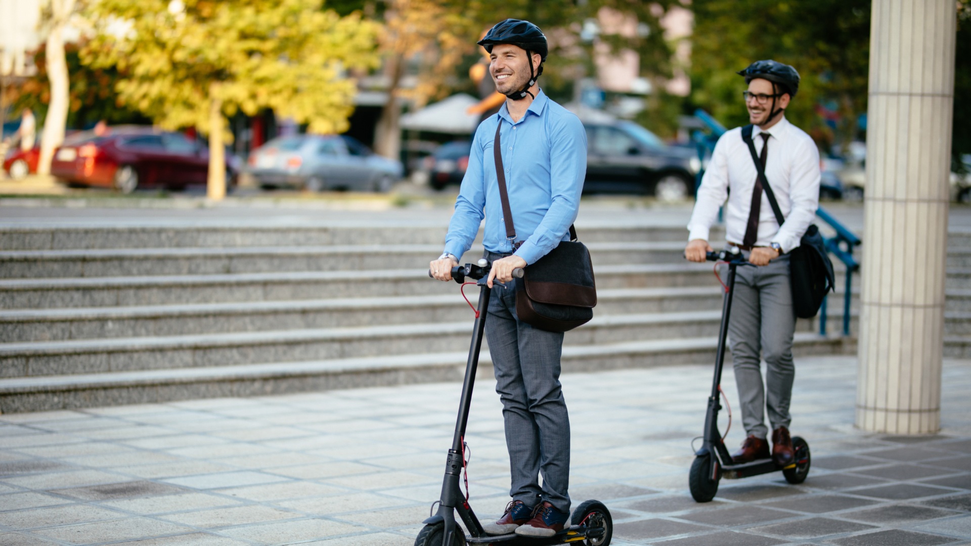 Men riding on electric scooters following electric scooter regulations.