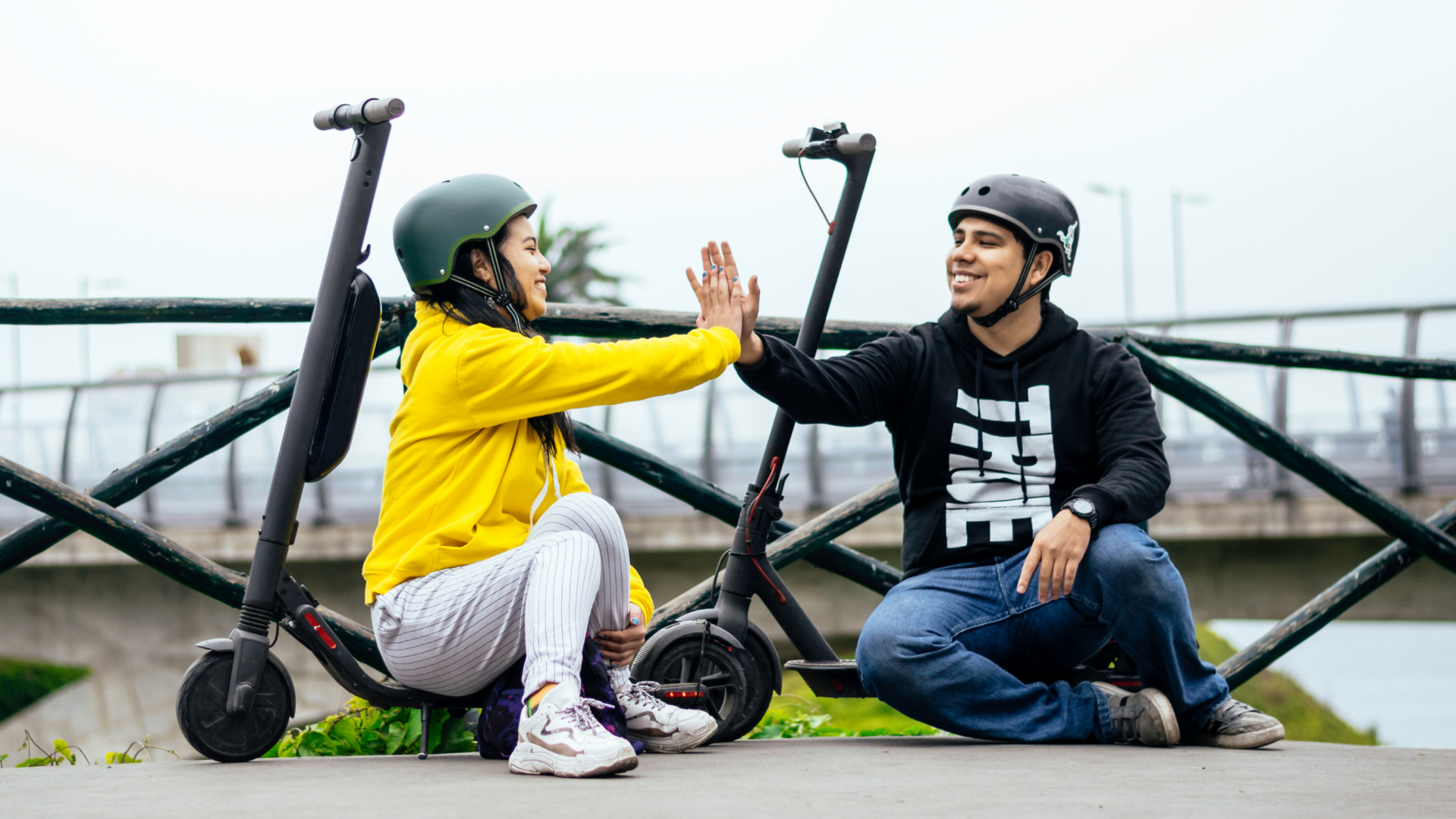Couple following electric scooter helmet laws.