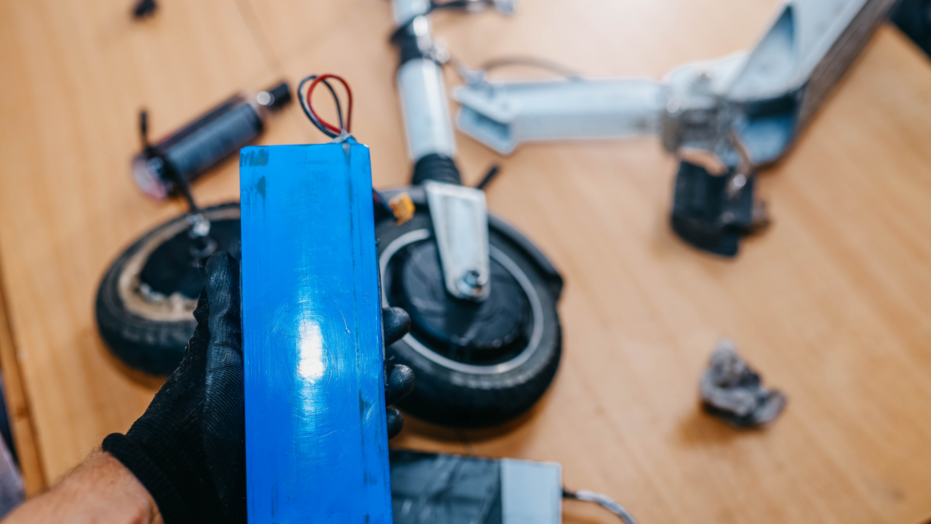 blue battery for electric scooter in repair shop how long do electric scooters last