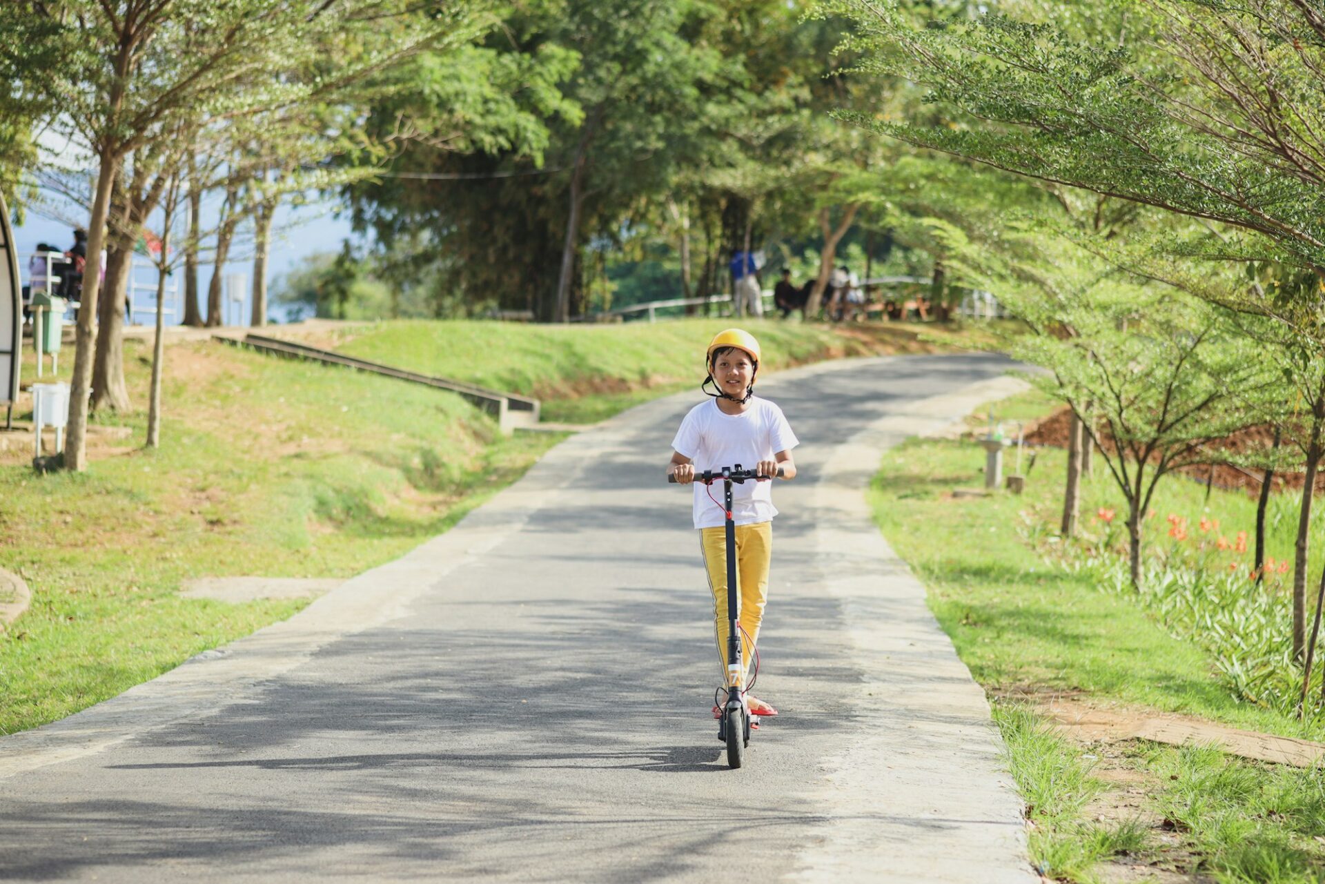 Young boy riding on a electric scooter with speed limits for kids.