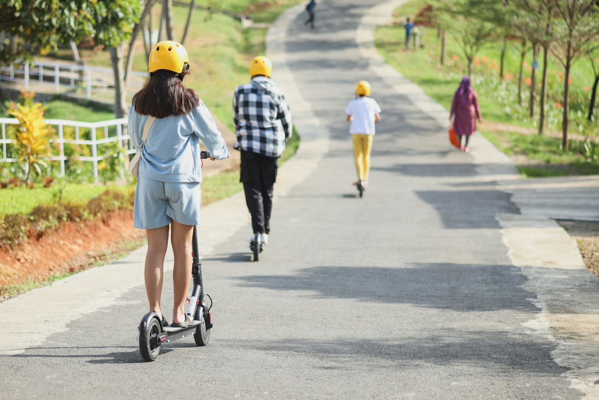 People riding electric scooter, are electric scooters safe