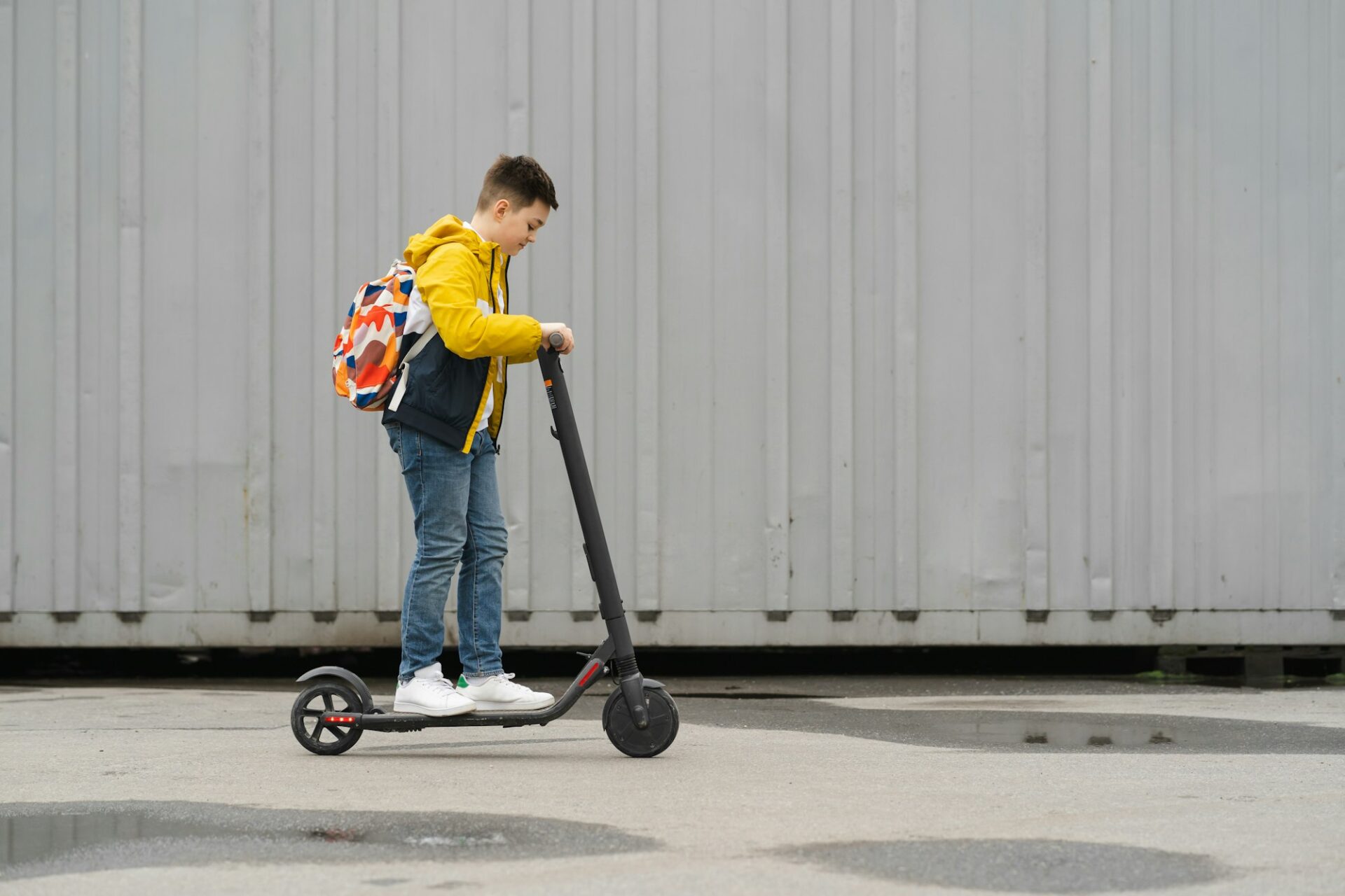 Teenager riding on a electric scooter for 13 year old.