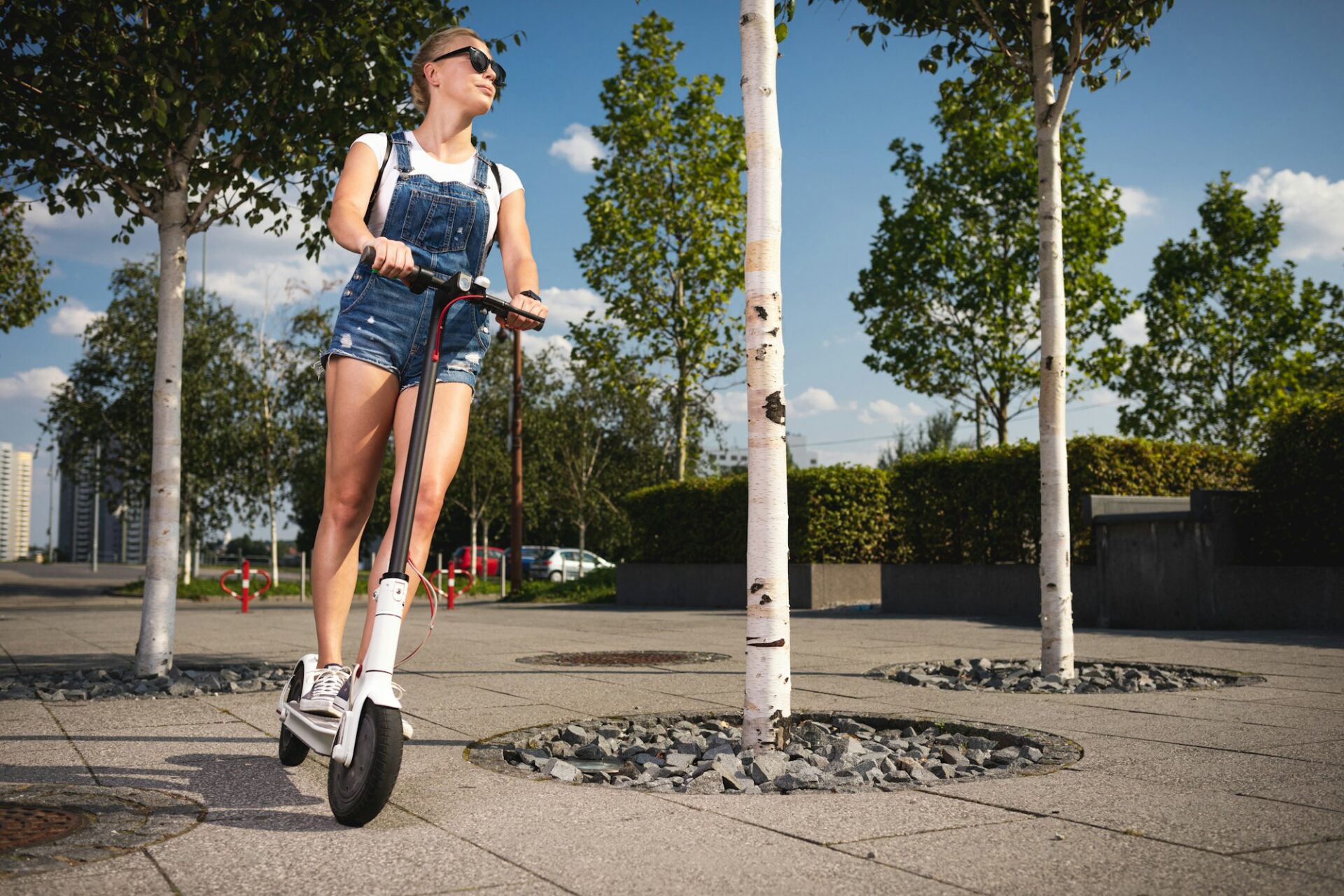 Young woman riding on electric scooter
