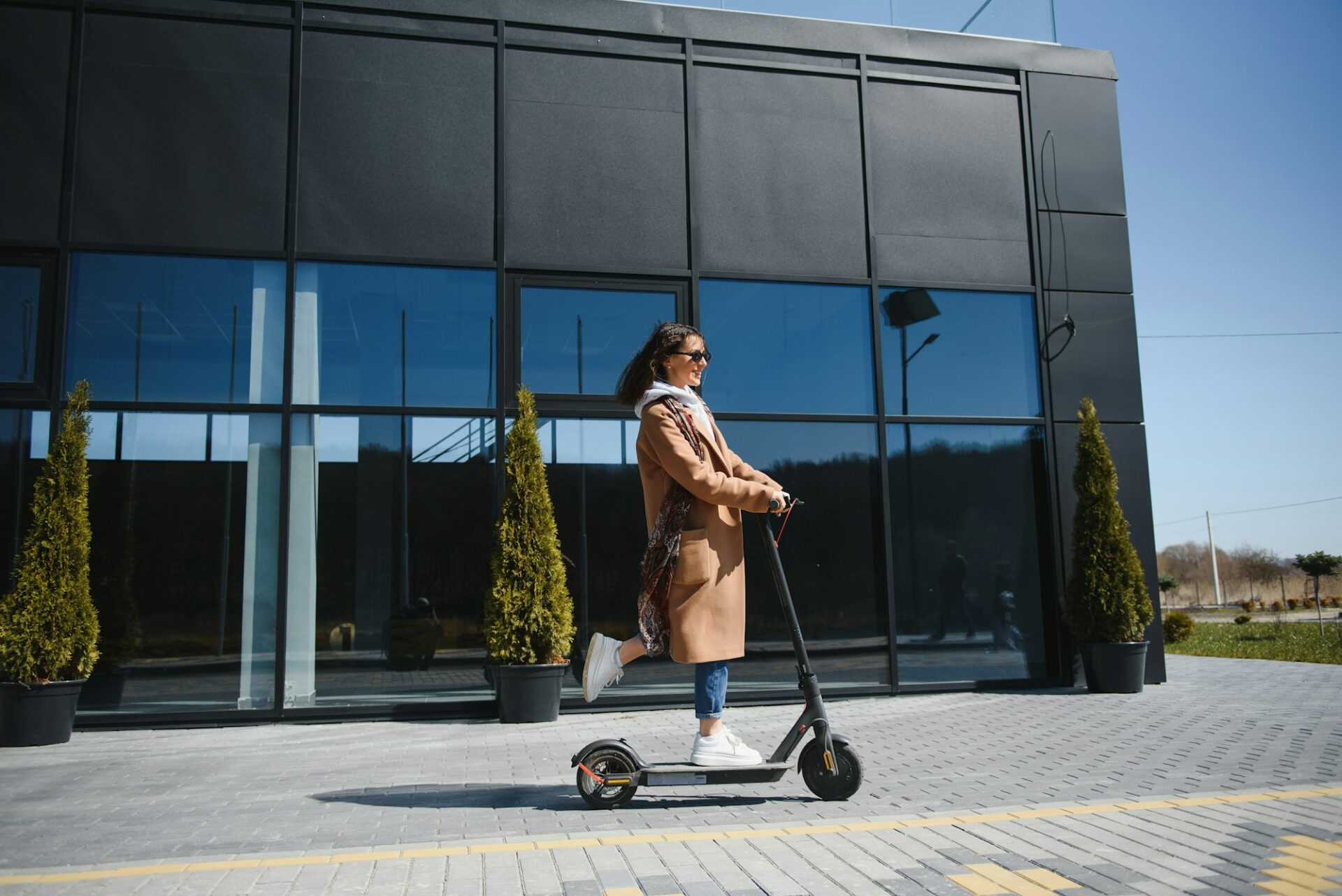 Young woman with electric scooter at the city 40 mile per hour electric scooter